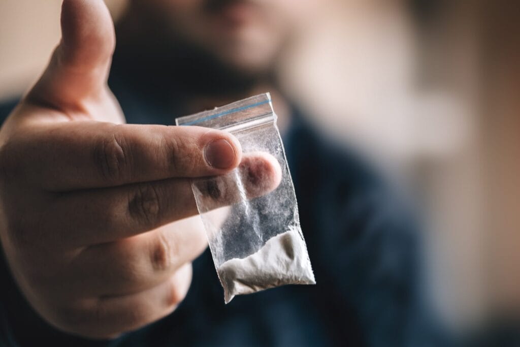 drug dealer holding cocaine
