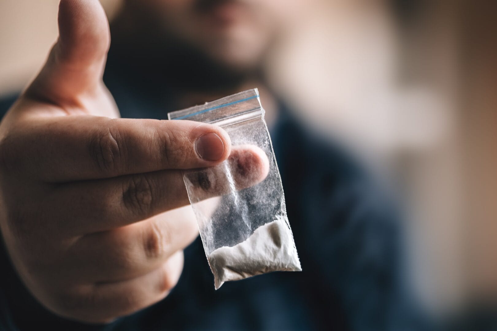 drug dealer holding cocaine