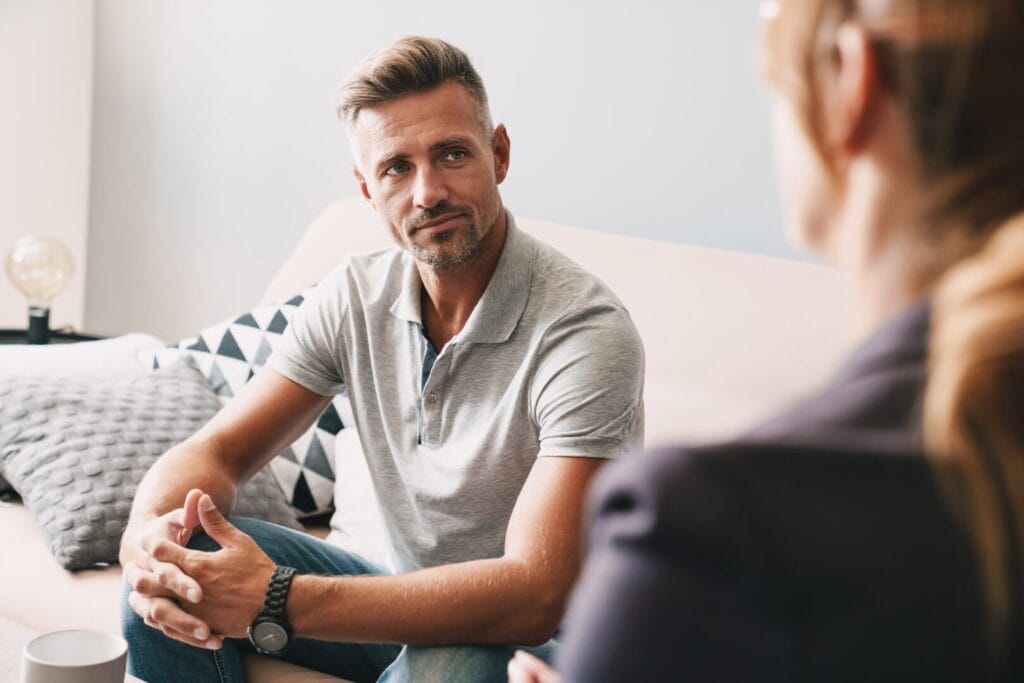 man in recovery talking with a therapist