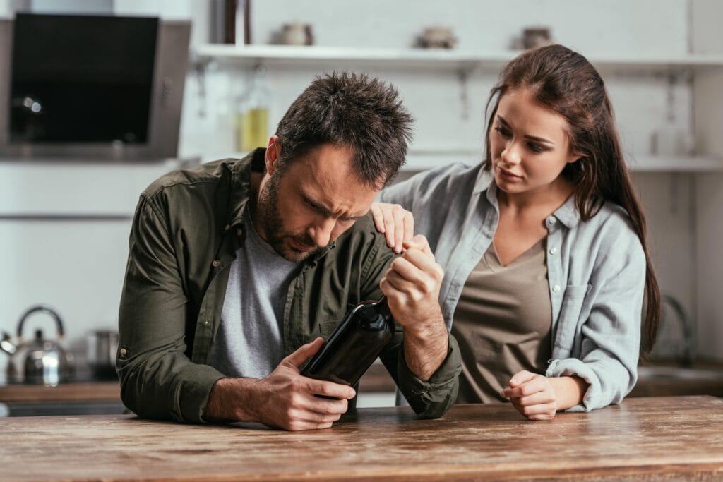 woman supporting alcohol addicted partner