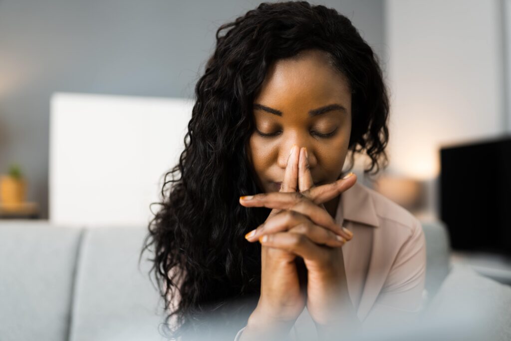 woman managing stress by meditating